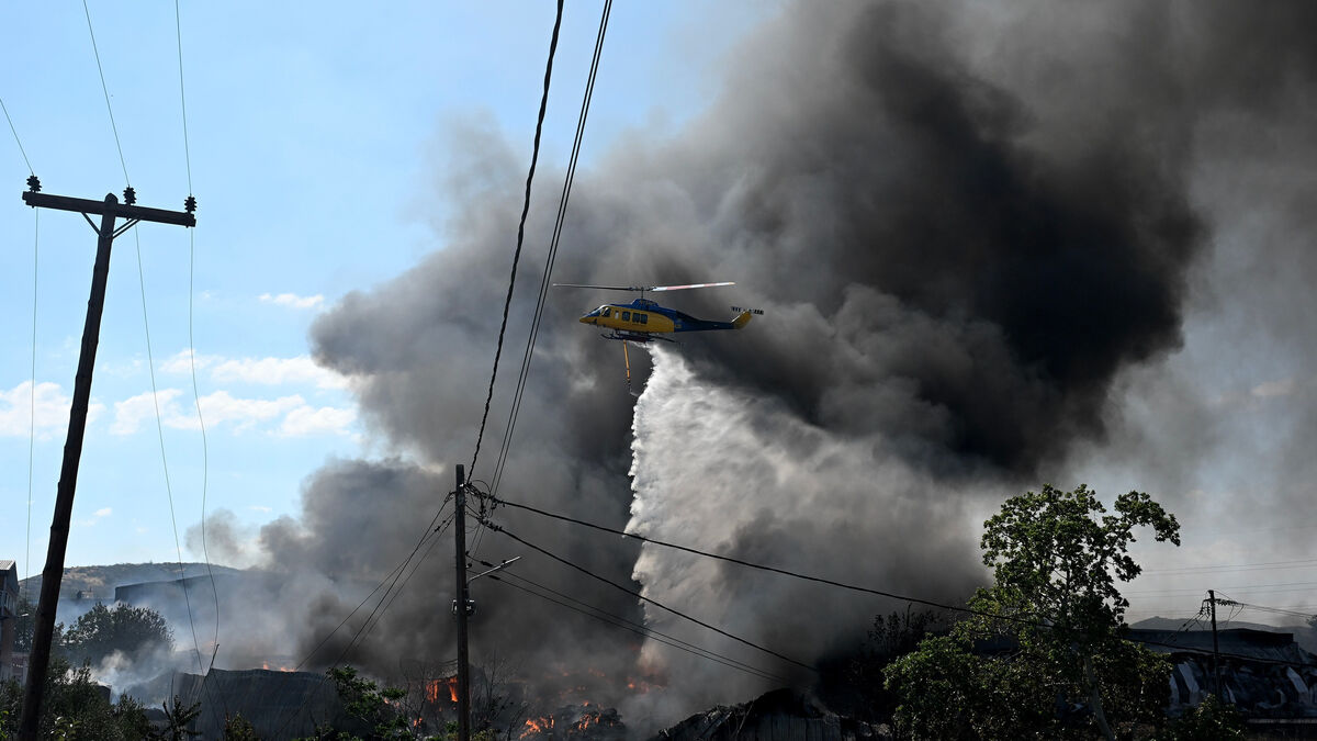 Thousands evacuated as wildfires rage
