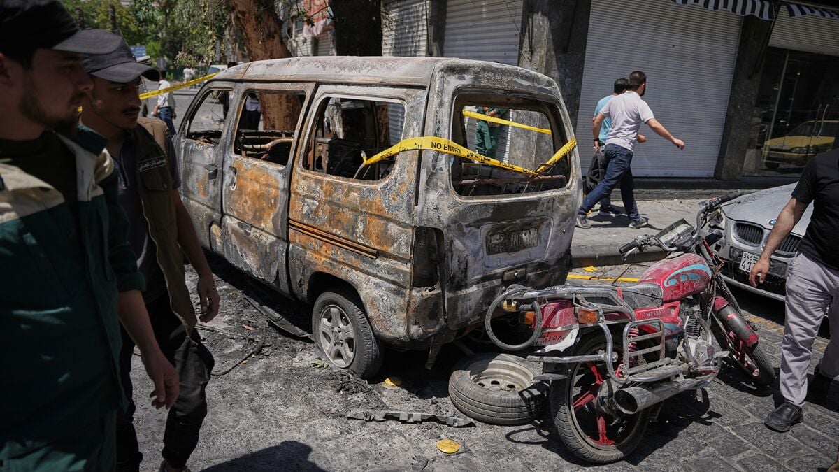 Syria says cell behind Damascus explosions arrested during Macron visit